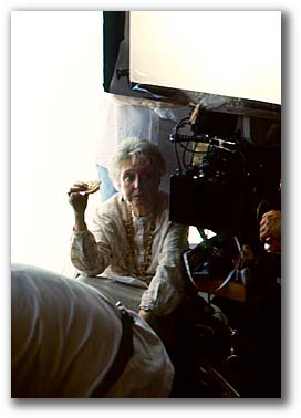 Celeste Holm huddles behind a camera...