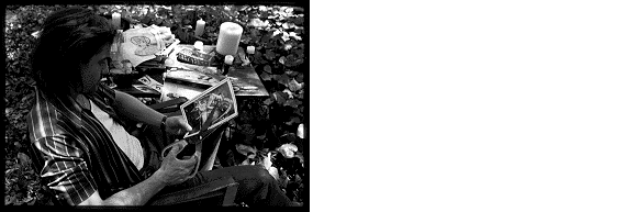  Fletcher cutting a woman's face from a magazine... 